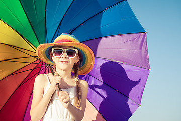 Image showing Little girl with umbrella standing on the beach at the day time