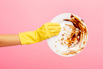 Image showing Hands in yellow protective gloves washing a plate