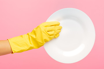 Image showing Hands in yellow protective gloves washing a plate