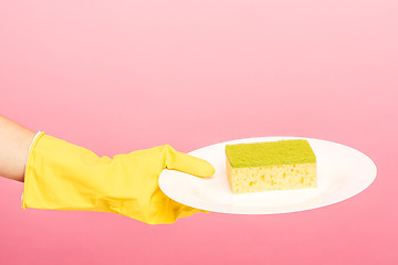 Image showing Hands in yellow protective gloves washing a plate