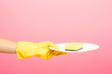 Image showing Hands in yellow protective gloves washing a plate