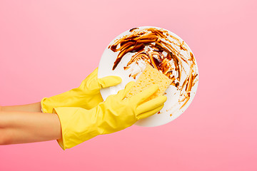 Image showing Hands in yellow protective gloves washing a plate