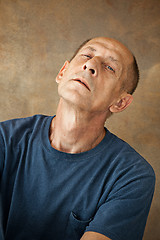 Image showing Worried mature man sitting at studio