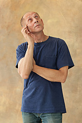 Image showing Worried mature man touching his head.