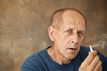 Image showing Worried mature man sitting at studio