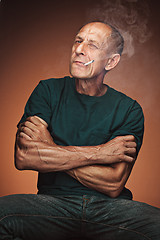 Image showing Worried mature man sitting at studio