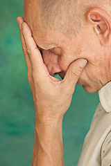 Image showing Worried mature man touching his head.