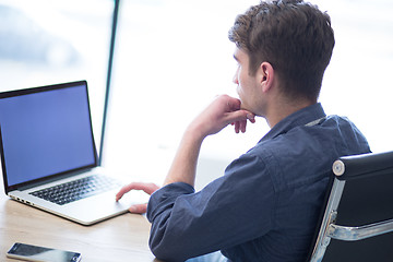 Image showing businessman working using a laptop in startup office