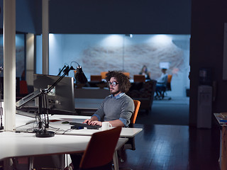 Image showing man working on computer in dark startup office