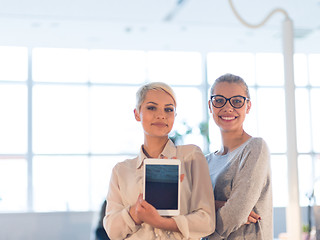 Image showing Pretty Businesswomen Using Tablet In Office Building during conf