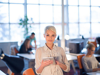 Image showing woman working on digital tablet in night office