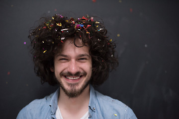 Image showing man blowing confetti in the air