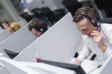 Image showing male call centre operator doing his job