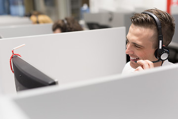 Image showing male call centre operator doing his job