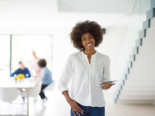 Image showing Portrait of  black casual businesswoman using tablet  with cowor