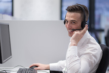 Image showing male call centre operator doing his job