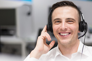 Image showing male call centre operator doing his job