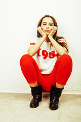 Image showing young pretty teenage hipster girl posing emotional happy smiling on white background, lifestyle people concept 