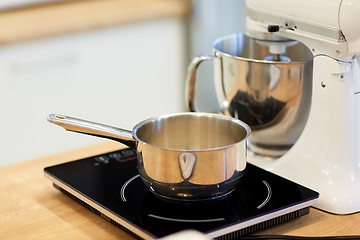 Image showing electric mixer and pot on stove at kitchen