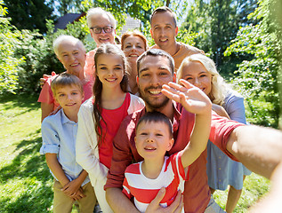 Image showing happy family taking selfie in summer garden