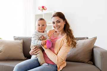 Image showing happy young mother with little baby at home