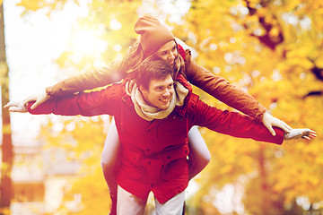 Image showing happy young couple having fun in autumn park