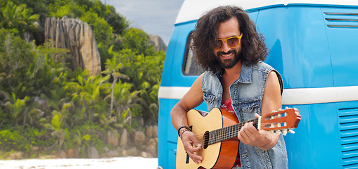 Image showing hippie man playing guitar at minivan car on island