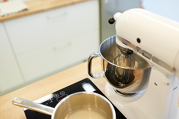 Image showing electric mixer and pot on stove at kitchen