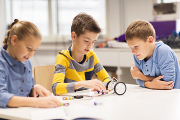 Image showing happy children building robots at robotics school