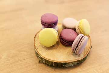 Image showing different macarons on wooden stand