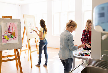 Image showing woman artists with colors painting at art school