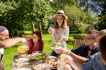 Image showing happy friends having dinner at summer garden party