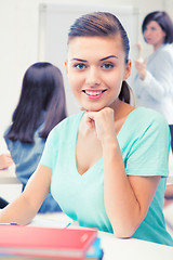 Image showing happy smiling student girl with books at school