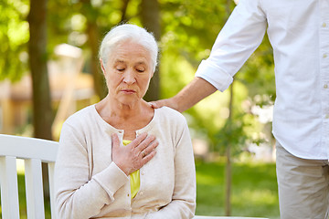 Image showing senior woman feeling sick at summer park