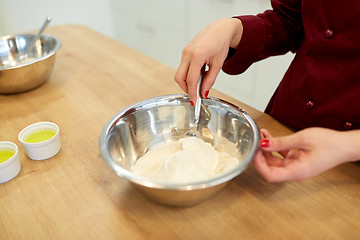 Image showing chef with flour in bowl making batter or dough