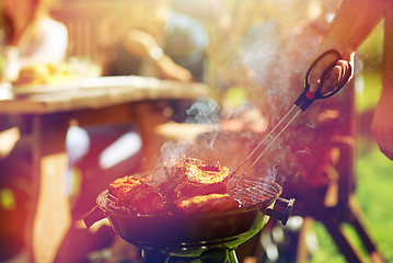 Image showing man cooking meat on barbecue grill at summer party