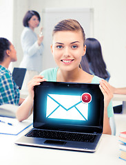 Image showing girl holding laptop with email sign at school