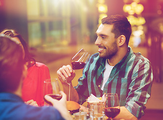 Image showing friends dining and drinking wine at restaurant