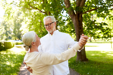 Image showing happy senior couple dancing at summer city park