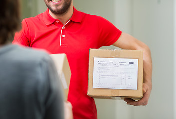 Image showing happy delivery man with parcel box and customer