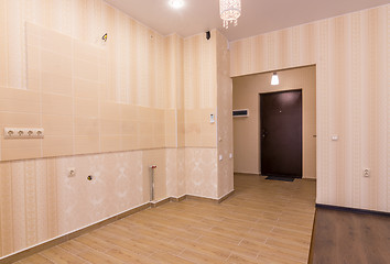 Image showing Interior of studio apartment, view from the room to the front door and kitchen without furniture