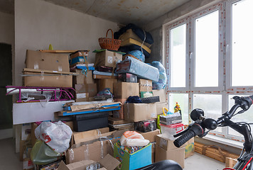 Image showing Moving to the apartment a new building, boxes and personal items against the background of concrete walls
