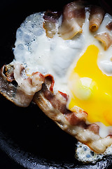 Image showing Fried eggs with bacon