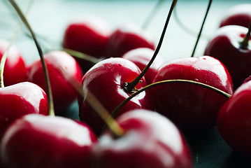 Image showing Ripe cherries on green