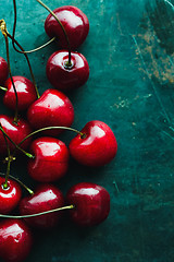 Image showing Ripe cherries on green