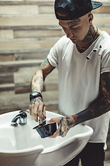 Image showing Crop tattooed barber making foam