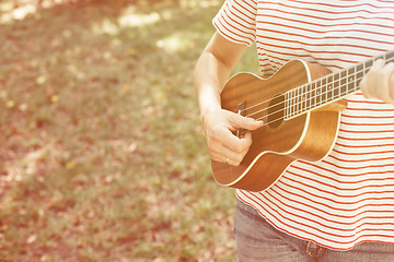 Image showing Anonymous woman playing ukulele