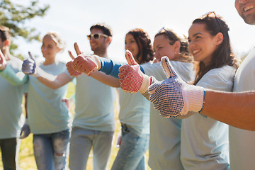 Image showing group of volunteers showing thumbs up outdoors