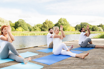 Image showing people making yoga and meditating outdoors