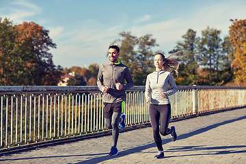 Image showing happy couple running outdoors